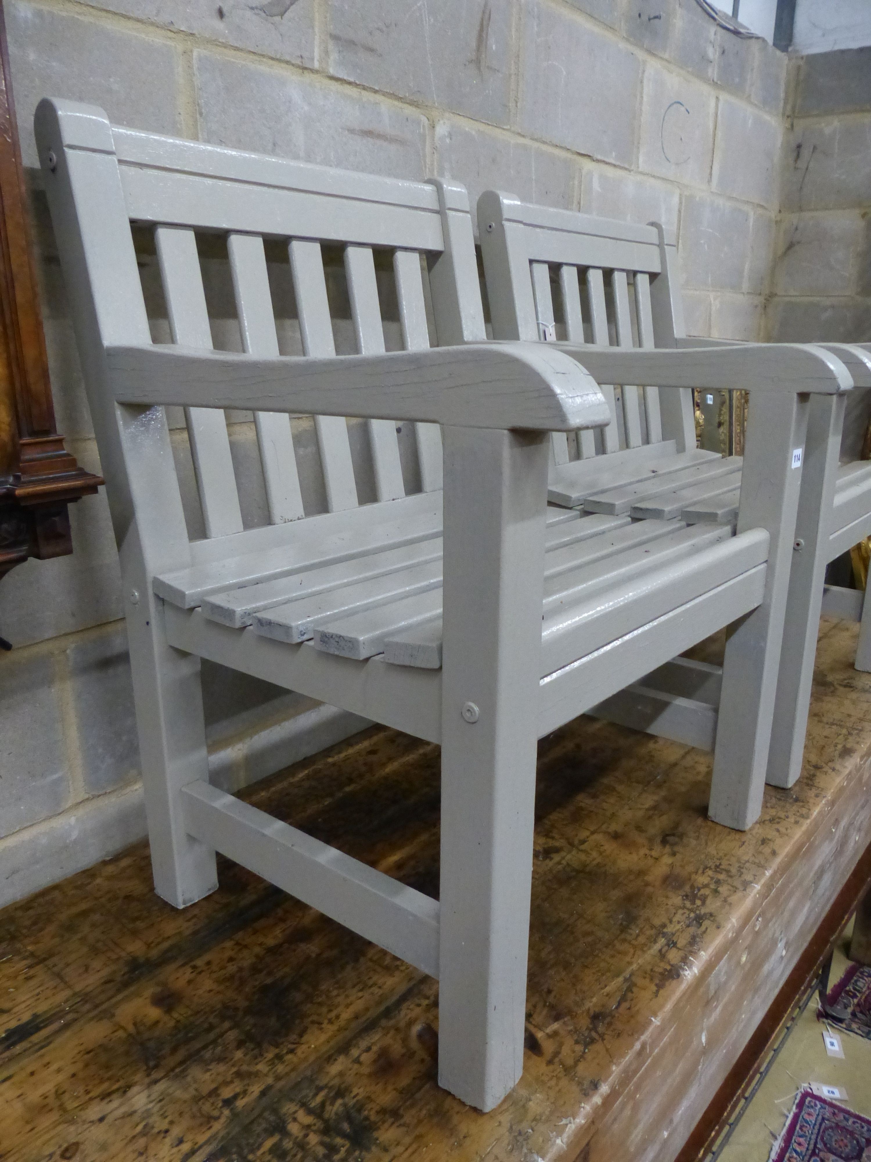 A pair of painted teak garden armchairs, W.65cm D.61cm H.88cm